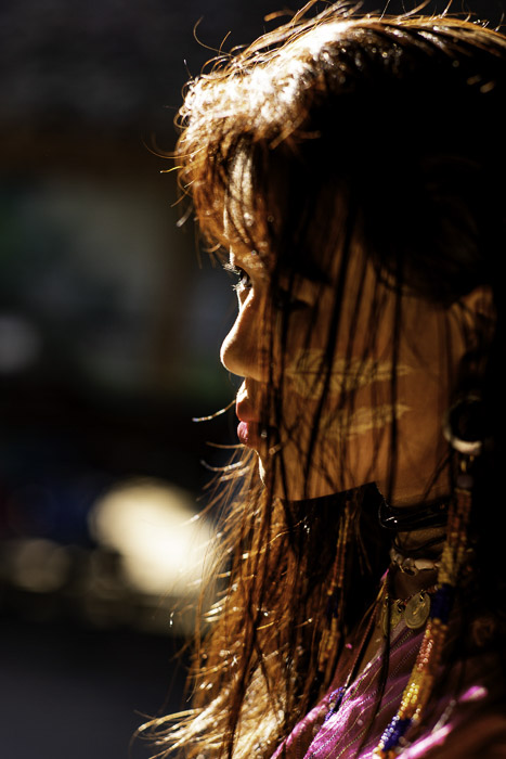 A close up portrait of a female model shot using backlight in photography