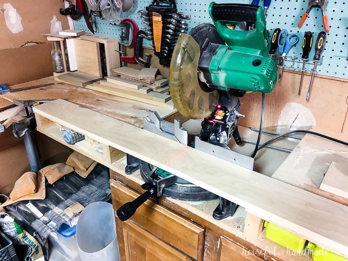 Miter saw tables do not have to be expensive or fancy. We used old kitchen cabinets ready for the trash and then built a top to be level with the miter saw bed with scraps and inexpensive wood. Housefulofhandmade.com