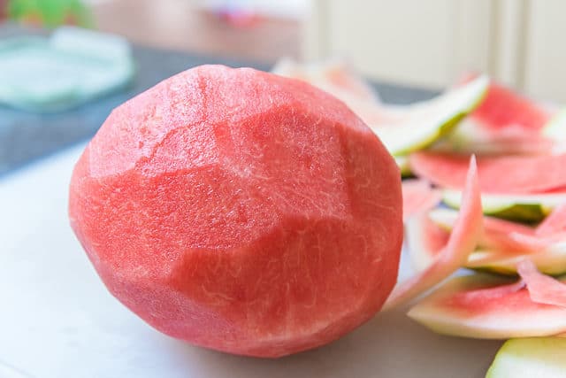 Whole Watermelon with Rind Removed on Cutting Board