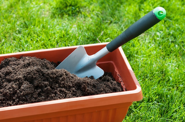 trowel in a compost filled container